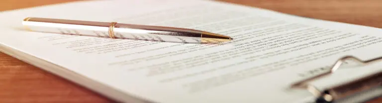 pen laying on a clipboard