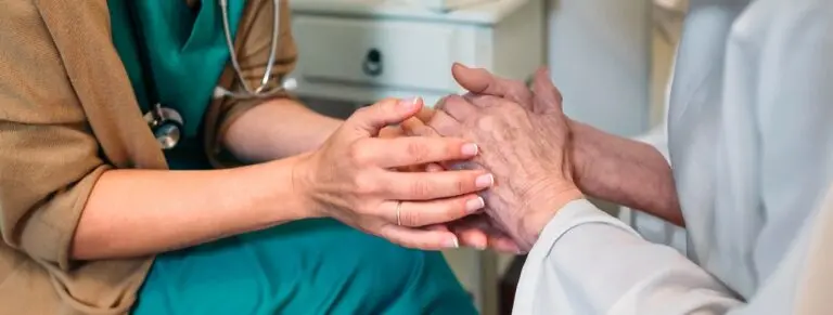 nurse holding patients hands