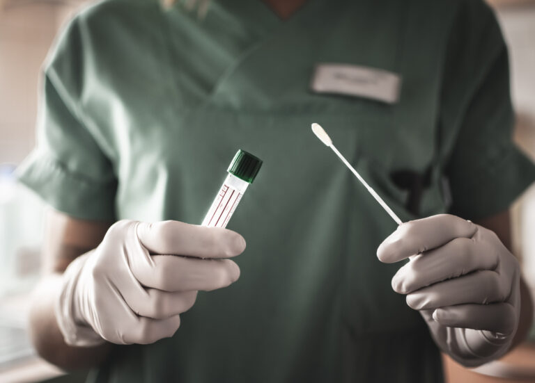 doctor holding swab and testing tube