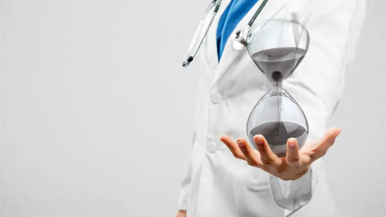 Doctor holding an hourglass