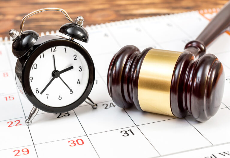 Judge's gavel with clock and calendar on table
