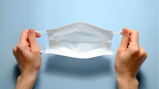 person holding a face mask