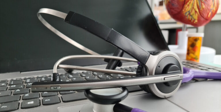 Stethoscope and headphone set on laptop keyboard