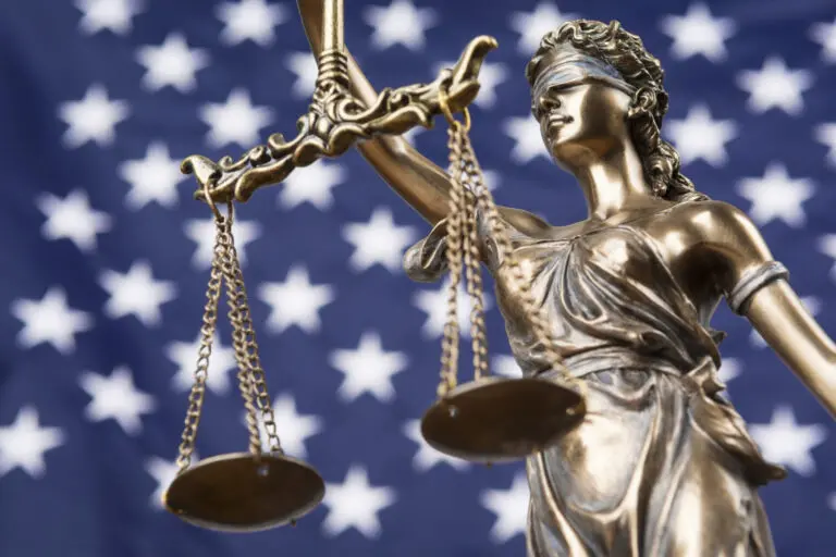 scales of justice with american flag background