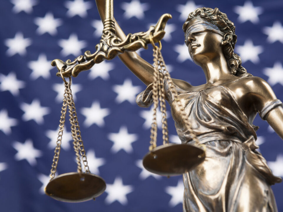 scales of justice with american flag background