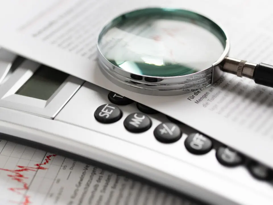magnifying glass and calculator