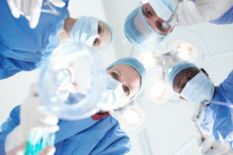 Anesthesiologists preparing to put a patient under.